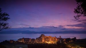 een nachtzicht op een resort aan de oever van een meer bij Hilton Yuxi Fuxian Lake in Chengjiang