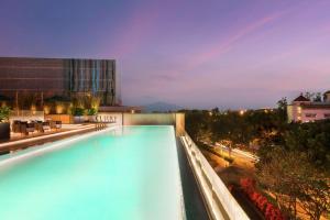 a swimming pool on top of a building at Joyze Hotel Xiamen, Curio Collection By Hilton in Xiamen
