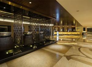 a lobby with a bar in a building at Hilton Xiamen in Xiamen