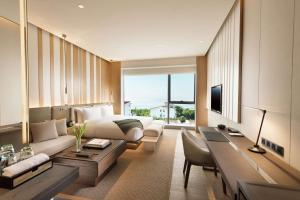 a hotel room with a bed and a desk at Joyze Hotel Xiamen, Curio Collection By Hilton in Xiamen