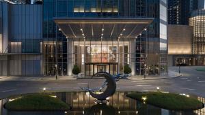 a sculpture in front of a building with lights at Hilton Foshan Shunde - Free Canton Fair Shuttle Bus in Shunde