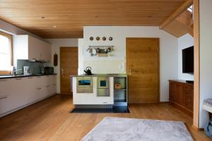 a kitchen with a stove top oven in a room at Ferienhaus Bergblick Bregenzerwald in Bregenz