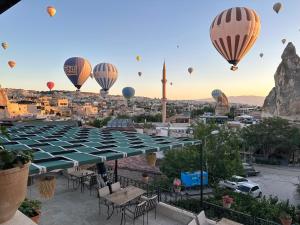 a group of hot air balloons flying over a city at Goreme House in Goreme