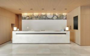 a lobby with a reception desk in a building at DoubleTree by Hilton Taipei Zhongshan in Taipei