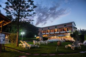 a building with a lot of chairs in the yard at Alexaria Holidays Homes in Lefkada