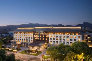 a large white building in a city at night at Doubletree By Hilton Beijing Badaling in Yanqing