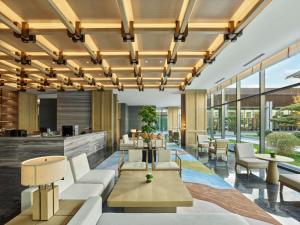 an office lobby with white furniture and large windows at Doubletree By Hilton Beijing Badaling in Yanqing