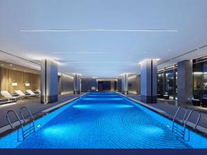 a swimming pool in the middle of a building at Doubletree By Hilton Beijing Badaling in Yanqing