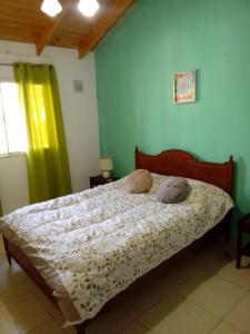 a bed with two pillows on it in a bedroom at Duplex Dorrego- Guaymallén in Guaymallen