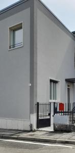 a white building with a window and a fence at Verona Urban Apartment in Verona
