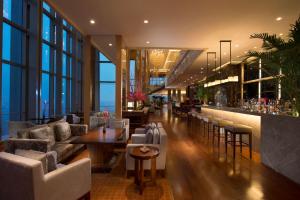 a lobby with couches and a bar in a building at Hilton Shijiazhuang in Shijiazhuang