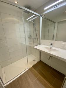 a bathroom with a glass shower and a sink at APARTMENT DACHSTEIN - neu im Haus Wieseneck in Ramsau am Dachstein