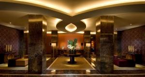a lobby of a hotel with a table and chairs at Hilton Beijing in Beijing