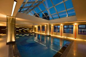a large swimming pool in a building with a ceiling at Hilton Beijing in Beijing
