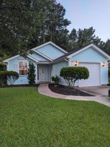 a blue house with a driveway at Great Central Location - Between Everything in Myrtle Beach