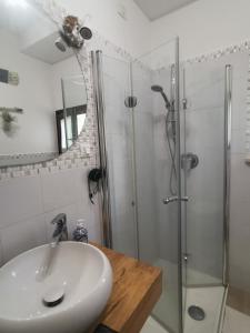 a bathroom with a sink and a shower at Il gelsomino in Fano