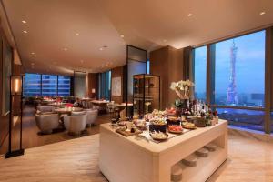 a hotel lobby with a buffet with a view of the eiffel tower at Conrad Guangzhou in Guangzhou