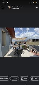 a view of a patio with a table and an umbrella at PATAYO LODGE in Bantama