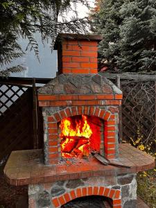 a brick oven with a fire inside of it at CHARZYKOWSKIE TARASY in Charzykowy
