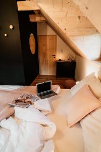 a laptop computer sitting on top of a bed at Nebesky 81 in Kunčice pod Ondřejníkem