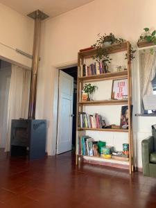 a living room with a book shelf with books at Palacio de la luna, casa única frente al mar in Cabo Polonio +15 photos
