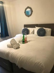 a bed with a tray with two bottles on it at Stonebridge Grove in Bramley