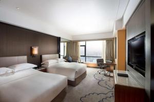 TV a/nebo společenská místnost v ubytování Hilton Zhongshan Downtown