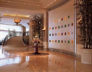 a lobby with a staircase and a vase of flowers at Hilton Chongqing in Chongqing