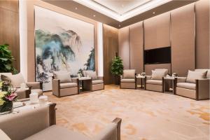 uma sala de espera com cadeiras e um quadro grande em DoubleTree by Hilton Hotel Shiyan em Shiyan