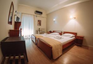 Postel nebo postele na pokoji v ubytování Hotel King Pyrros