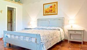 A bed or beds in a room at Masseria Borgo del Gallo