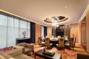 a living room with a table and a dining room at DoubleTree by Hilton Hotel Putian in Putian