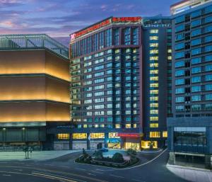 a rendering of a building with two tall buildings at Hilton Garden Inn Zhongshan Guzhen in Zhongshan