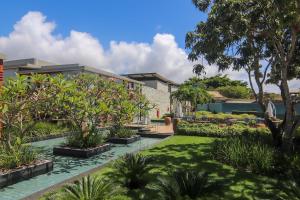 a garden with trees and plants in front of a building at île de Pipa - Ma Plage Hotel in Pipa