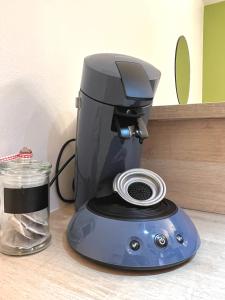 a coffee maker sitting on top of a table at « Petit Paris » - T2 centre ville Parking/balcon in Albertville