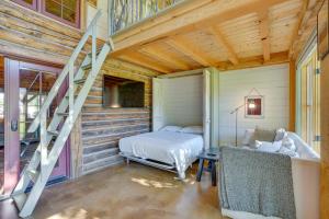 a bedroom with a bed and a staircase in a house at Luxury Log Cabin Less Than 15 Mi to Downtown Moab! in Moab