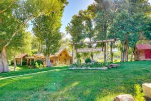 a garden with a gazebo in a yard at Luxury Log Cabin Less Than 15 Mi to Downtown Moab! in Moab