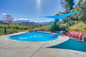 a swimming pool with a blue canopy over it at Luxury Log Cabin Less Than 15 Mi to Downtown Moab! in Moab