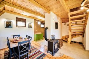 a dining room with a wood stove and a bedroom at MoMa Escape in Borje