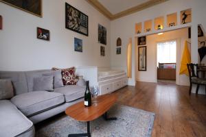 a living room with a couch and a table at Adorable Apartment in The Heart of Primrose Hill in London