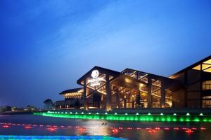 a building with green lights at night at DoubleTree By Hilton Jiaxing in Jiaxing
