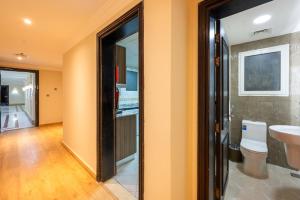 a bathroom with a toilet and a sink at Saray Musheireb Hotel Suites and Apartment in Doha
