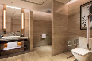 a bathroom with a toilet and a sink at Hilton Jinan South Hotel & Residences in Jinan