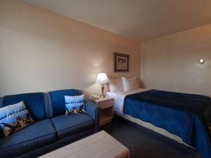 a hotel room with a bed and a couch at Westview Motel in Vegreville