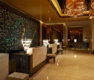 a lobby of a hotel with a chandelier at Hilton Zhengzhou in Zhengzhou