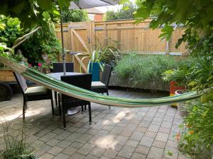 a hammock in a garden with a table and chairs at The Vineyard (Home of the think pod) in Portsmouth