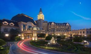 a building with a clock tower at night at Hilton Qingdao Golden Beach - Beer Halls in Huangdao