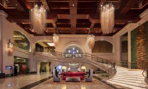 a lobby with a red couch in the middle at Hilton Qingdao Golden Beach - Beer Halls in Huangdao