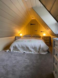 a bedroom with a large bed in a attic at The Greig 1B in Wadhurst