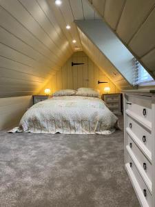 a bedroom with a large bed in a attic at The Greig 1B in Wadhurst